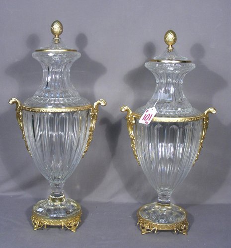 BEAUTIFUL PAIR OF ITALIAN CRYSTAL AND DORE BRONZE: A heavy pair of cut crystal urns with gilt dore bronze handles and ormolu appointments. Note: These urns were originally purchased for $9,000. 27" high, 13" wide.