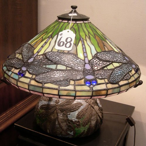VERY FINE BRONZE AND LEADED GLASS DRAGONFLY LAMP: A heavy bronze base with dragonflies in high relief and finished with mosaic leaded glass work supports a dome shaped shade in blue, green and yellow coloration. 14" high, 16 1/2" dia.