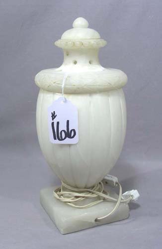 HAND CARVED ITALIAN ANTIQUE ALABASTER LAMP: A square base supports a bulbous alabaster lamp with lift off lid. Electrified. 14" high, 5 1/2" wide.