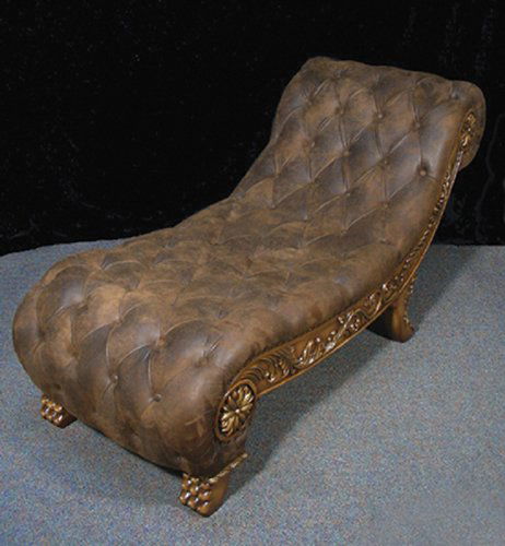 FINE HAND CARVED WOOD AND LEATHER CHAISE LOUNGE: A curved chaise lounge with distressed leather. Sides and feet with ornate carving. Excellent condition. 6' long.