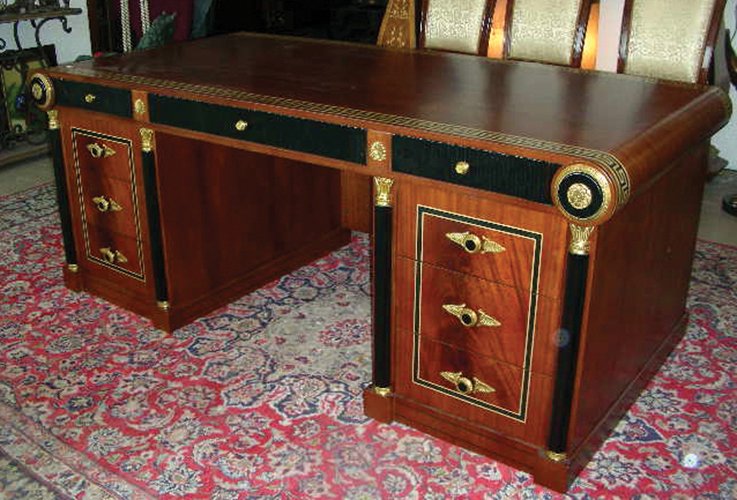 SPECTACULAR HAND CARVED AND INLAID ITALIAN DESK: A heavy desk with six drawers. Top with an inlaid band in Greek key design. Ormolu decorations. Very fine quality. 31" high, 77" wide, 39" deep.