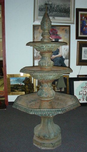 VINTAGE HEAVY CAST IRON FOUNTAIN: A triple tier fountain with octogon basins and a pineapple finial. 87" high, 40" dia.
