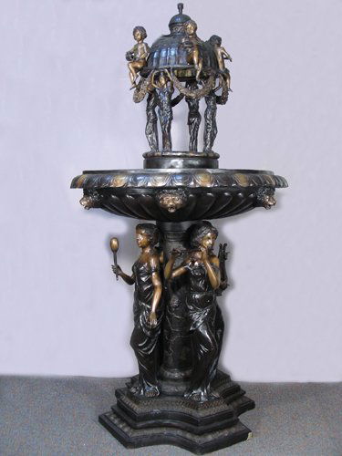 OUTSTANDING MONUMENTAL FRENCH BRONZE FIGURAL FOUNTAIN: An ornate base with four ladies playing musical instruments. Center of fountain with large scalloped bronze basin with lion's head motif. Top center domed section with four women and four seated child