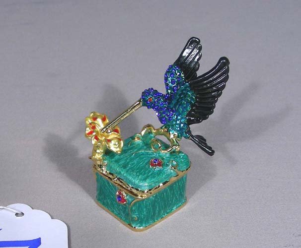 METAL AND ENAMEL HUMMINGBIRD BOX: Hummingbird also encrusted with blue rhinestones. 2 3/4" high.