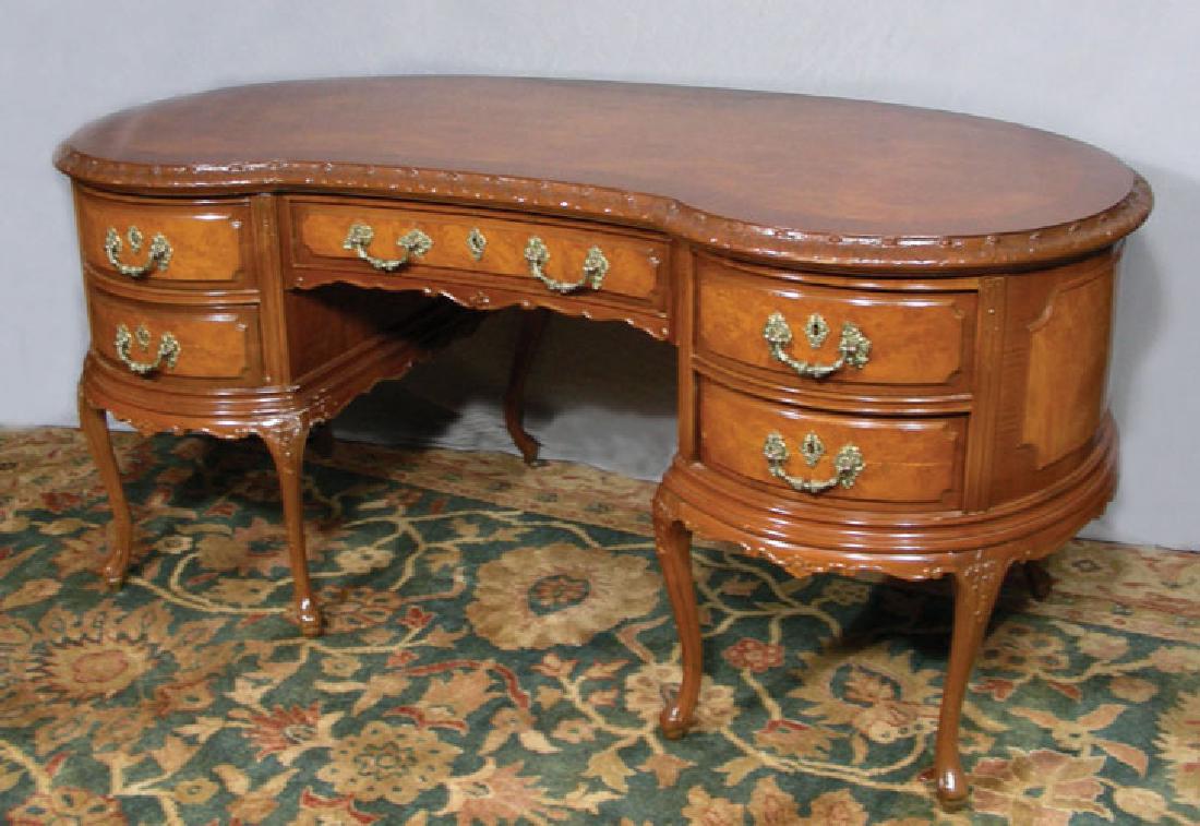 FINE CARVED BURLWOOD KIDNEY SHAPED DESK: Five drawers with ornate ormolu handles. 31" high, 67" wide, 34" deep.