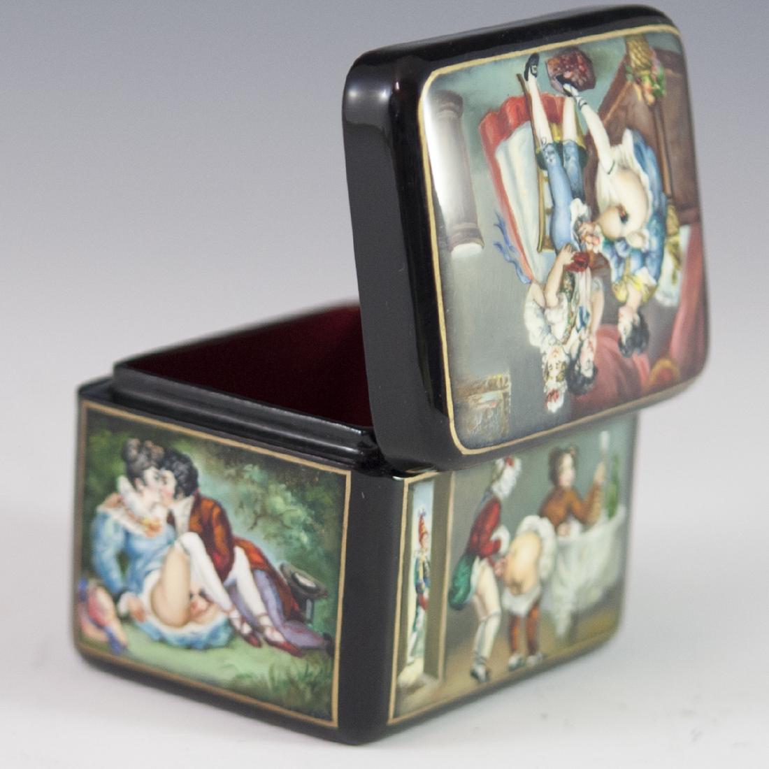 Russian Erotic Lacquered Papier Mache Box: DESCRIPTION: A Russian erotic lacquered papier mache box. Features 5 erotic Edwardian era scenes, on each side as well as lid of the cubical box. Opens to reveal a red lacquer interior and finished wi
