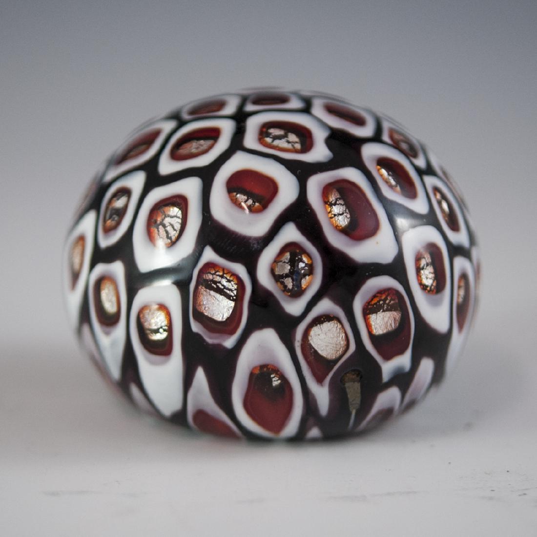 Fratelli Toso "Windows" Murano Glass Paperweight: DESCRIPTION: A Fratelli Toso "Windows" Murano glass paperweight. Features mosaic murrine glass accents outlined in red and white hues, embellished with silver foil accents along the centers. CIRCA: 20