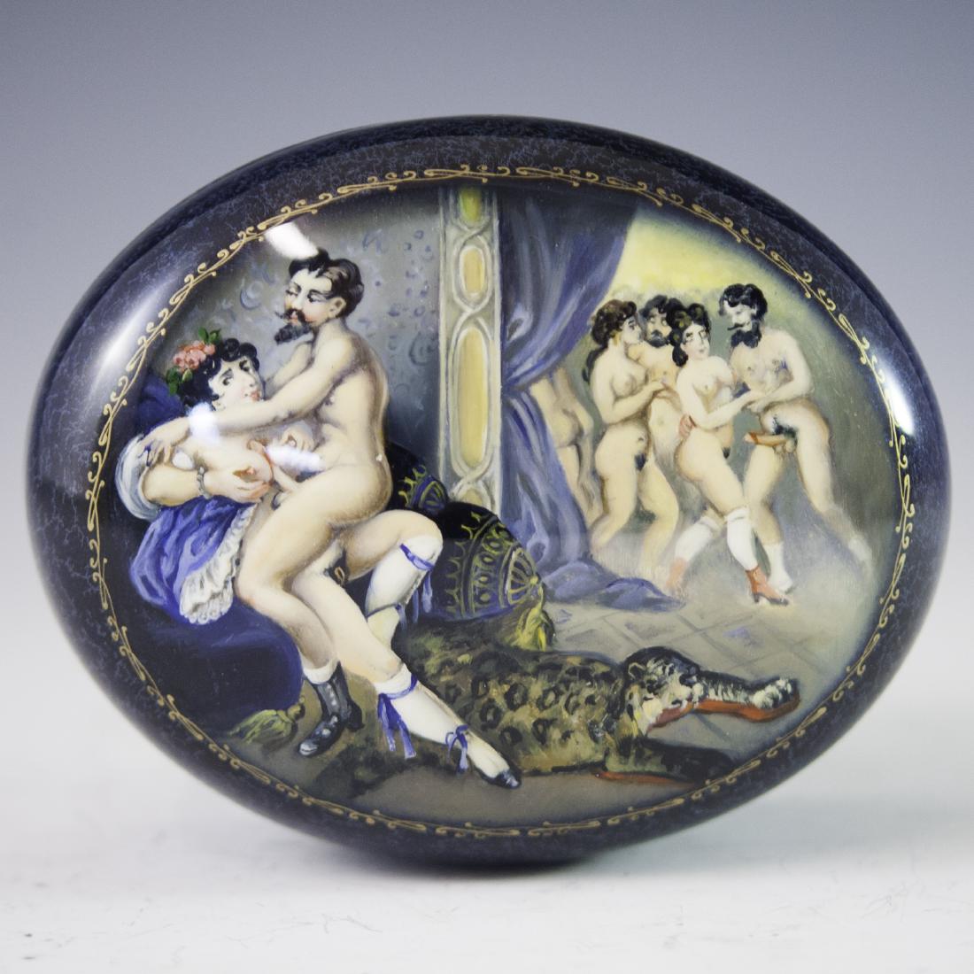 Russian Erotic Lacquered Papier Mache Box: DESCRIPTION: A Russian lacquered papier mache box. Features an erotic Victorian era scene. The scene is enveloped with a royal blue base hue and finished with gilded and glittered accents. CIRCA: 21st