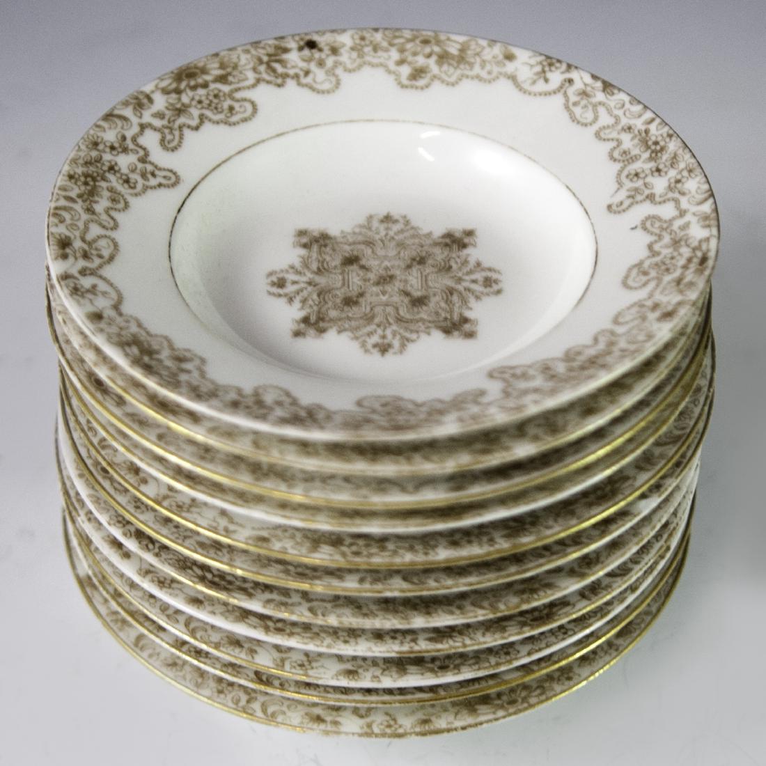Limoges Porcelain Cocktail Plates: DESCRIPTION: A Set of 11 Limoges porcelain cocktail plates featuring hand painted floral motifs enveloping a center Rococo floral motif. Finished with gilded trims and accents. Marked :"L R L France" 