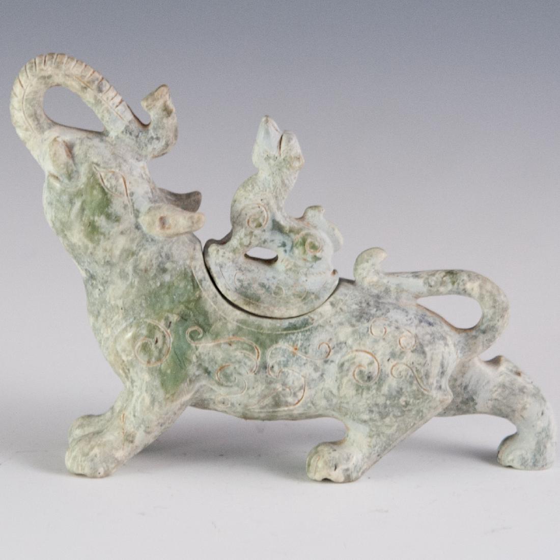 Han Dynasty Style Carved Jade Gajasimha Censer: DESCRIPTION: An antique Han Dynasty style carved jade censer of Gajasimha. Seen here with the head of al elephant with its trunk arching upwards, fitted with the body of a lion. Fitted with a mythical
