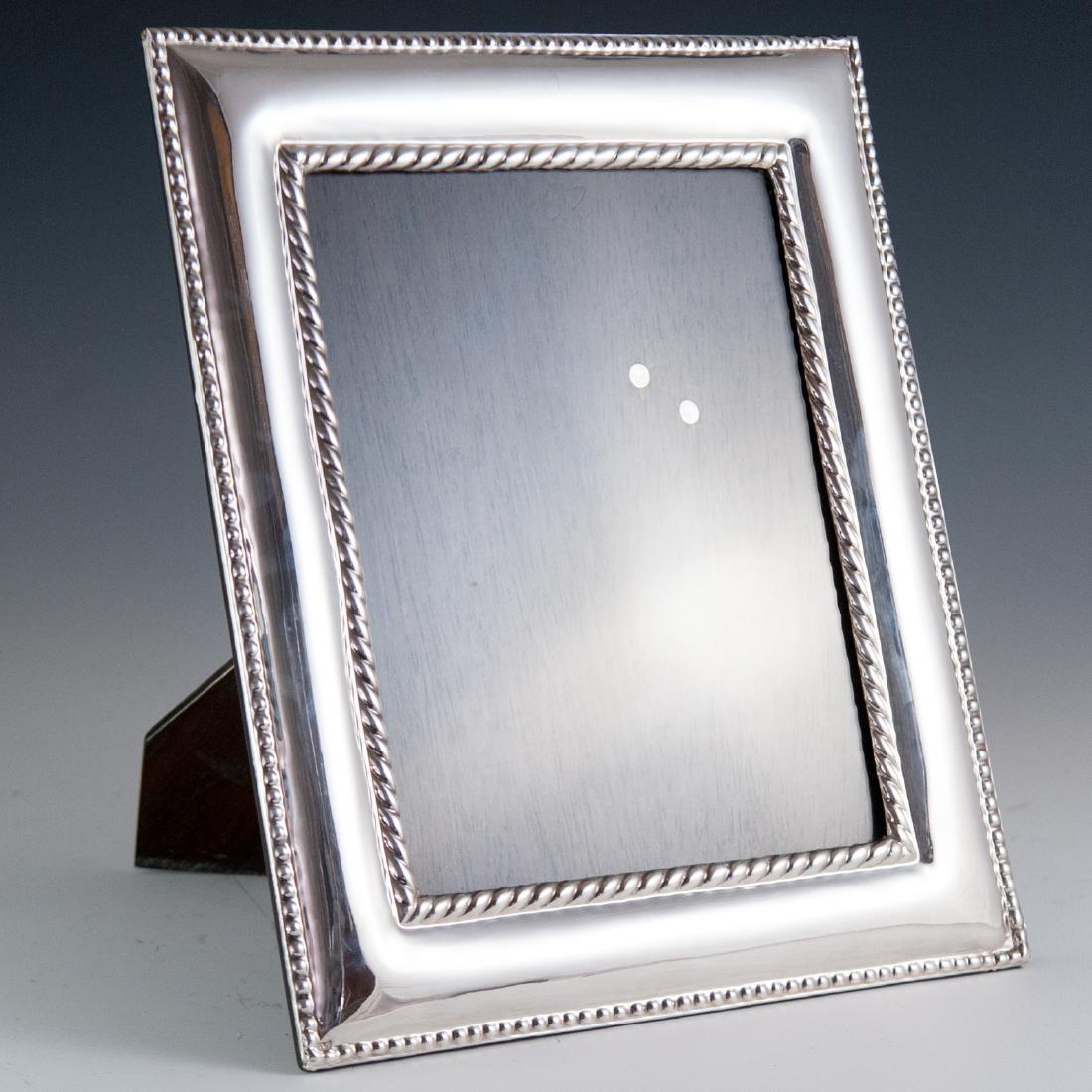 Italian Il'Argento Sterling Picture Frame: DESCRIPTION: An Il'Argento sterling picture frame. Features an overall bubbled repousse design further garnished with dotted and rope designs along the borders of the frame and center glass panel. CIR