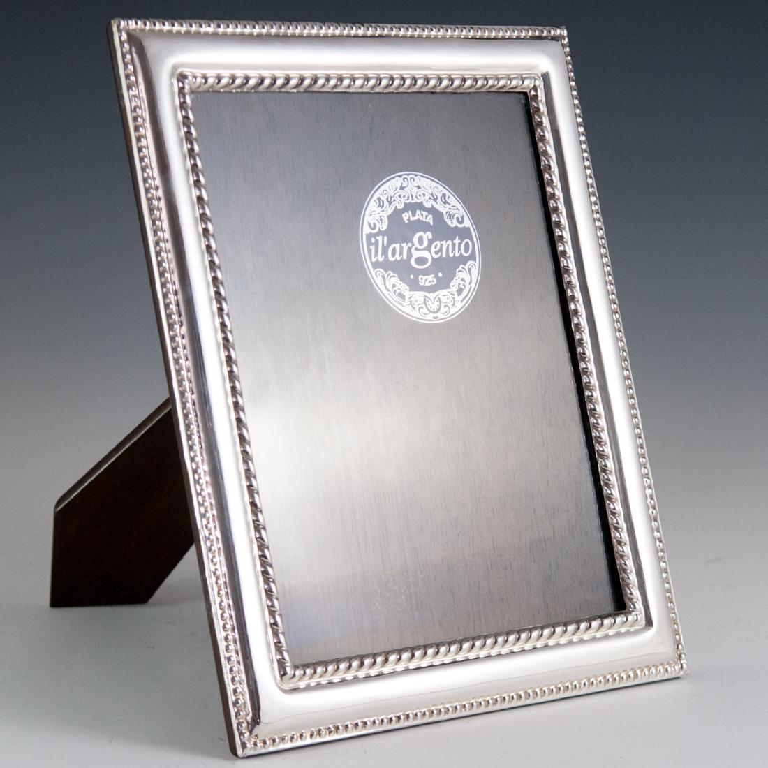 Italian Il'Argento Sterling Picture Frame: DESCRIPTION: An Il'Argento sterling picture frame. Features an overall bubbled repousse design further garnished with dotted and rope designs along the borders of the frame and center glass panel. CIR