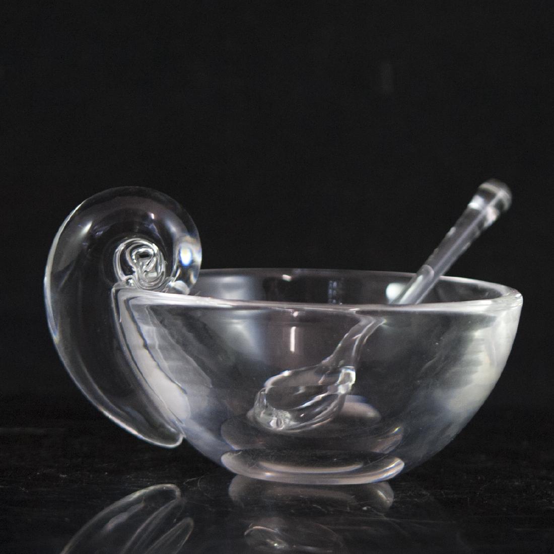 Steuben Crystal Sugar Bowl: DESCRIPTION: A Steuben crystal sugar bowl. Comprises of a bowl and spoon. The bowl features a rotund tapering form with a scrolled handle and a deep scalloped center. Marked "Steuben" along the unders