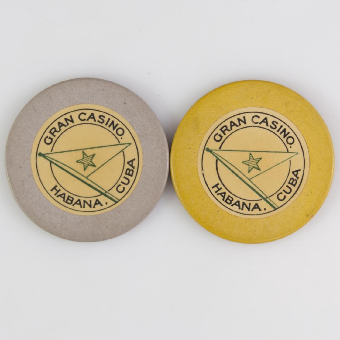 Gran Casino Habana Cuba Chips: DESCRIPTION: A set of two Gran Casino chips from Havana, Cuba. Comprises of a grey and yellow chip, centered by a flag. CIRCA: Mid 20th Ct. ORIGIN: Cuba DIMENSIONS: Diameter:1.5" CONDITION: Fair condi