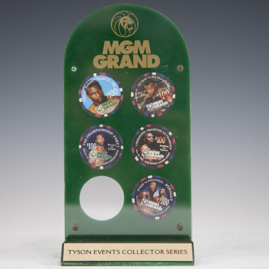 MGM Grand Casino Mike Tyson Chip Set: DESCRIPTION: A set of 5, $100.00 MGM Grand Casino chip set, framed in an acrylic case comprising of the following: - August 19th, 1995 Tyson Vs. Mcneely chip. - November 4th, 1995 "Tyson II...The Road