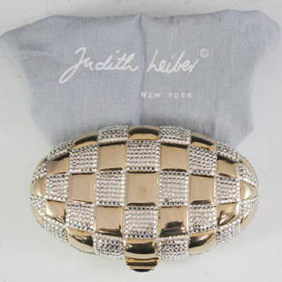 Judith Leiber Crystal Minaudiere Clutch: DESCRIPTION: A Judith Leiber minaudiere clutch. Features an overall oval, gilt metal foundation with checkered, swarovski crystal patterns. Fitted with an amethyst adorned clasp that opens to reveal t