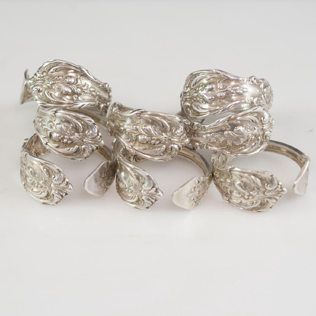 Reed & Barton Sterling "Francis I" Napkin Rings: DESCRIPTION: A set of 8 Reed & Barton sterling "Francis I" patterned napkin rings. Features a folded design embellished with repousse fruits enveloped by a scrolled rococo floral motif cartouche. Mark