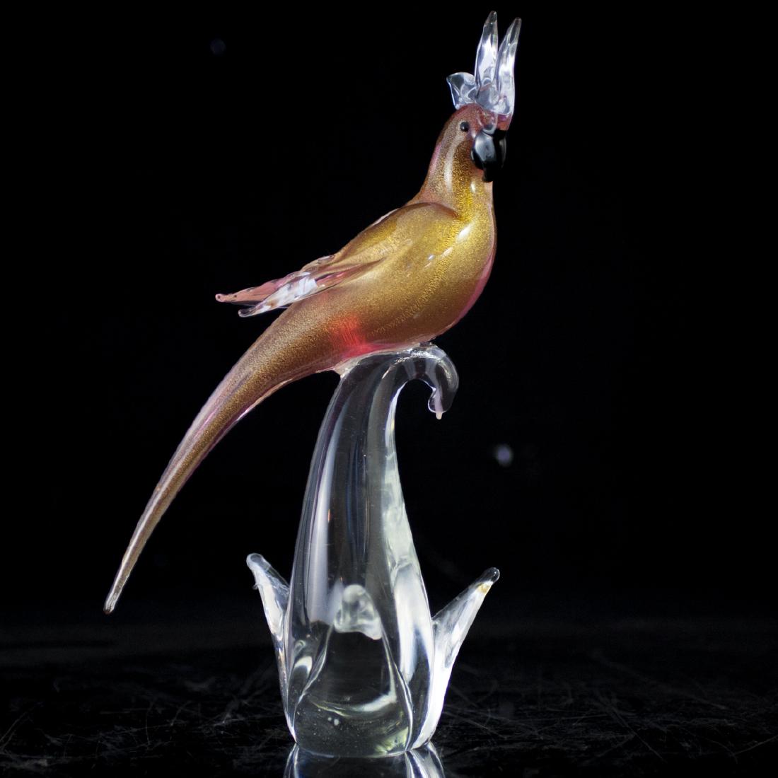 Murano Glass Cockatoo: DESCRIPTION: A Murano glass sculpture of a cockatoo standing atop a clear glass base. Finished with gold flakes along the interior. Unsigned. CIRCA: Late 20th Ct. ORIGIN: Italy DIMENSIONS: H:13.25" L: