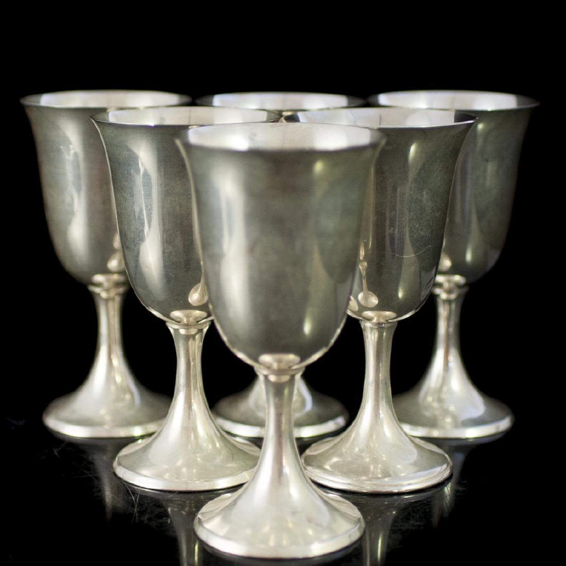 Watson Sterling Wine Goblets: DESCRIPTION: A set of 6 Watson, sterling, wine goblets. Features fluted base and stem and an everted rim. Marked along the undersides:"Sterling Silver" along with traditional Watson maker's marks. CIR
