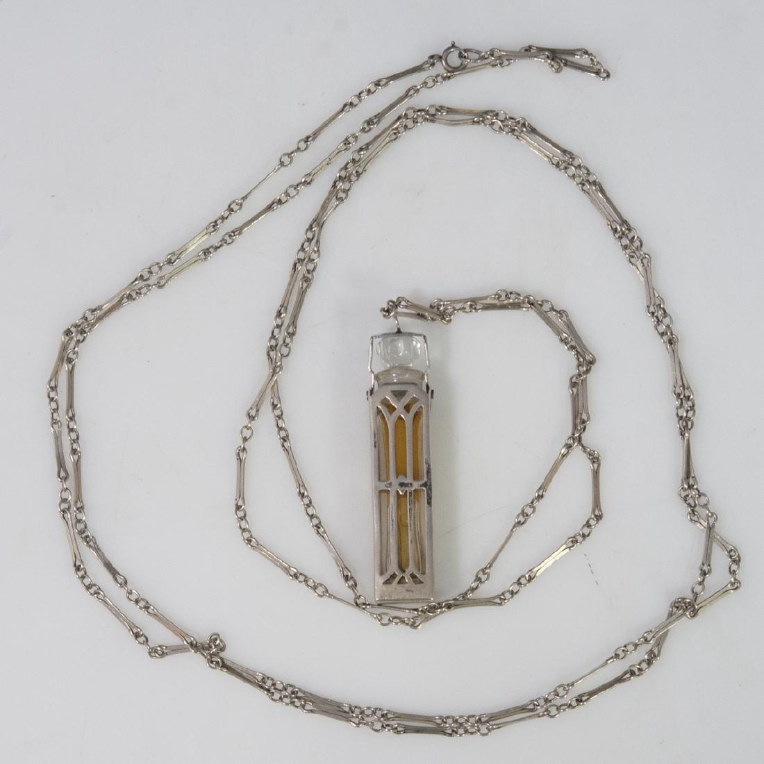 Wells Sterling Art Deco Cage Perfume Bottle: DESCRIPTION: An Art Deco, Wells sterling cage perfume bottle. Features an open work sterling case fitted with a spring loaded perfume bottle that pops up when the swiveled lid is pushed down. Includes