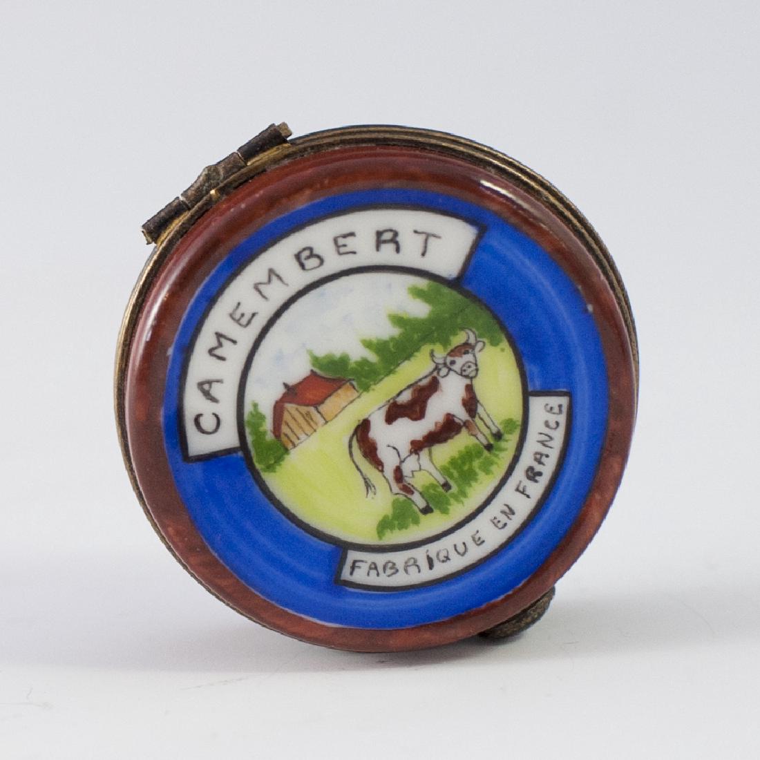 Limoges Porcelain Pill Box: DESCRIPTION: A Limoges porcelain pill box in the motif of a wheel of Camembert cheese. Marked along the underside:"Peint Main Limoges France Loeumiaus". CIRCA: Late 20th Ct. ORIGIN: France DIMENSIONS: