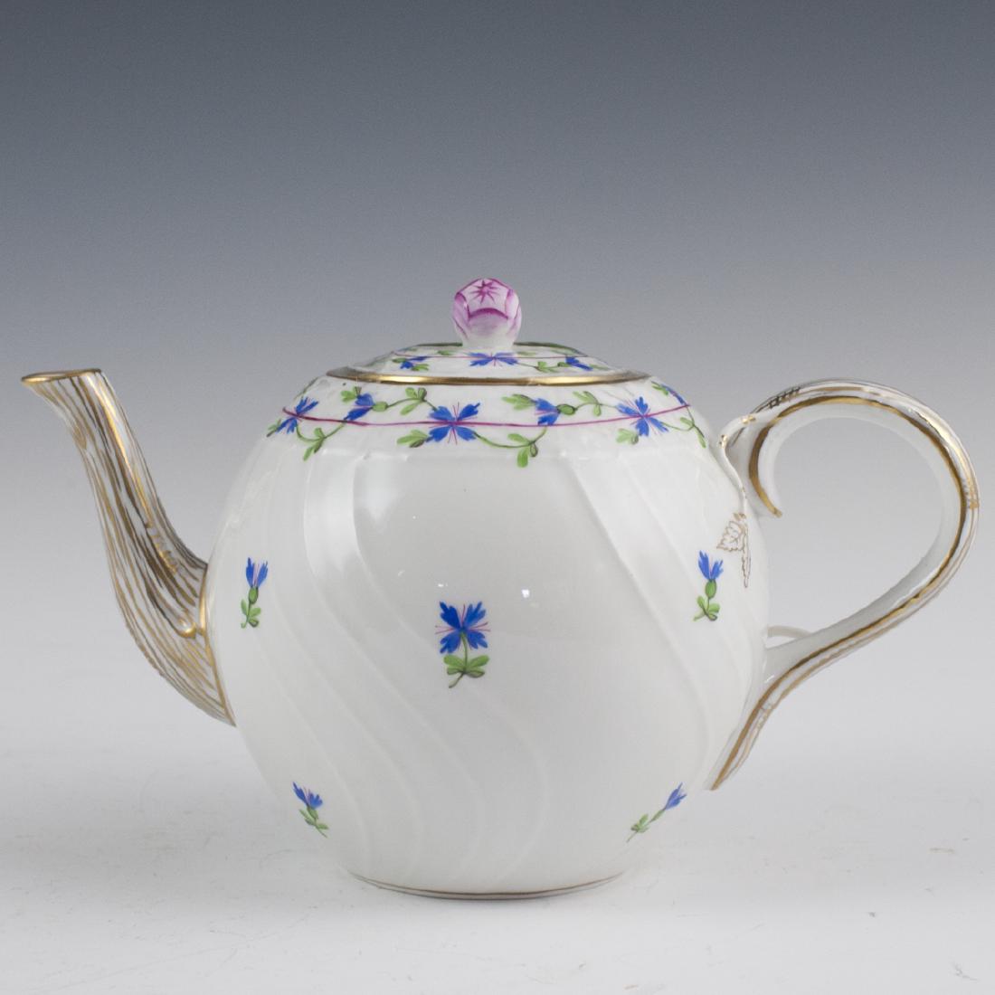 Herend Porcelain "Blue Garland" Teapot: DESCRIPTION: A Herend "Blue Garland" patterned teapot. Features garlands of blue flowers and green winding stems, as well as decorated with a tree branch motif handle and spout. Finished with an appli