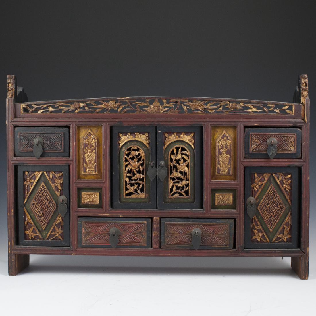 Carved Chinese Wooden Personal Altar: DESCRIPTION: A carved Chinese, wooden personal altar. Features an overall wooden foundation embellished with four side pull drawers, 2 center doors, and two pull drawers centering the bottom. Finished