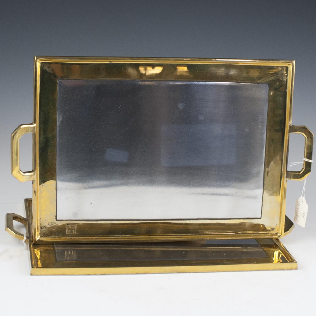 David Marshall Mixed Metal Serving Trays: DESCRIPTION: A pair of David MArshall mixed metal serving trays. Features a rectangular form with a brass foundation and aluminum center. Finished with two handles flanking the center. Marked with Dav