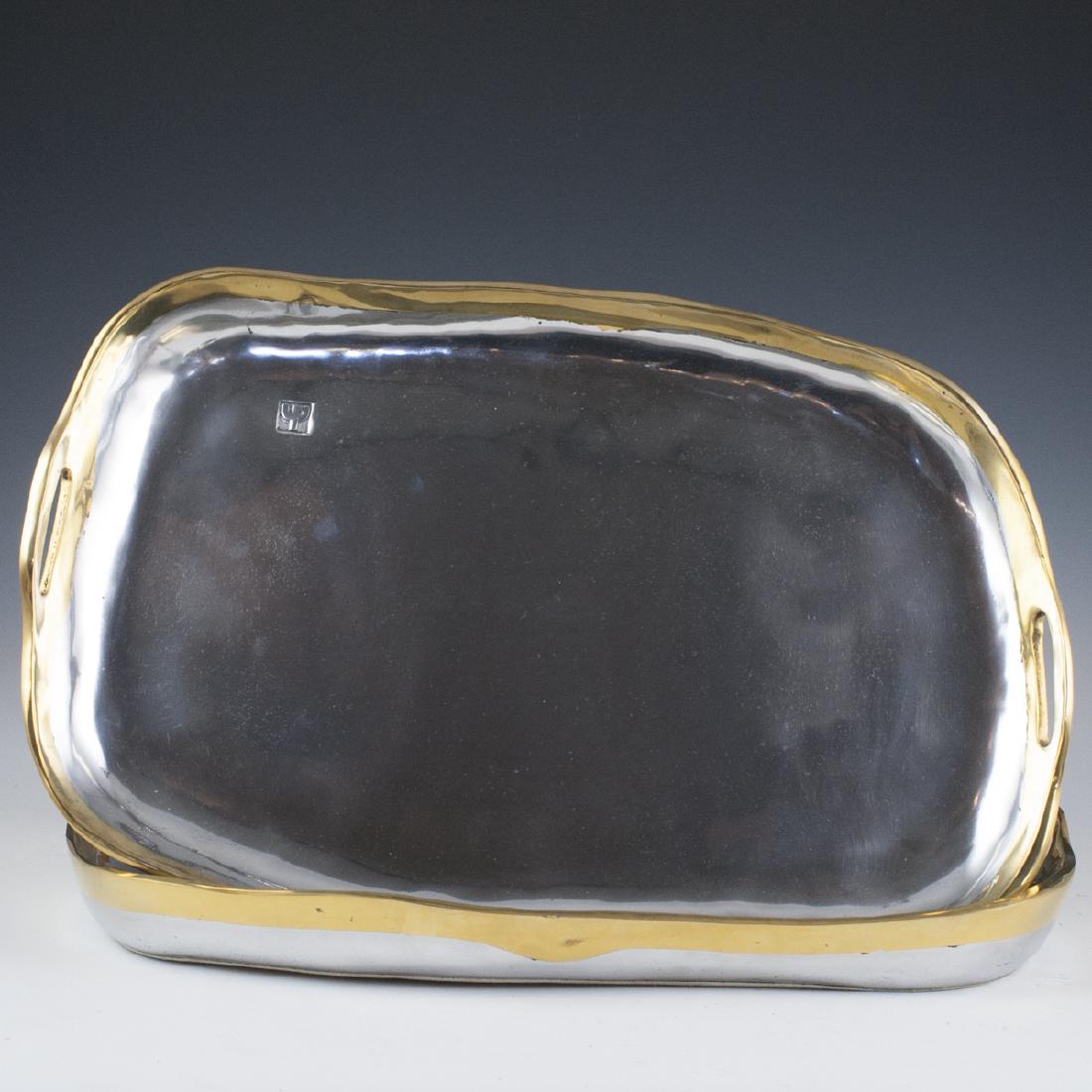 David Marshall Mixed Metal Serving Trays: DESCRIPTION: A pair of mixed metal David Marshall serving trays. Features aluminum foundations with brass edges. Designed in an asymmetrical waveform and finished with two side handles. Marked with Da