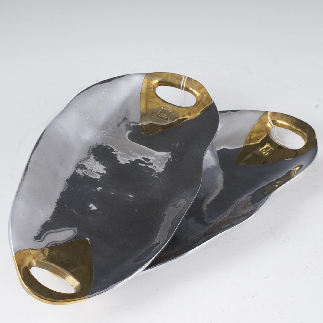 David Marshall Mixed Metal Soap Trays: DESCRIPTION: A pair of David Marshall mixed metal soap trays. Features an oval form with an aluminum foundation and brass handles. Marked with David Marshall stamps. CIRCA: 20th Ct. ORIGIN: Spain DIME