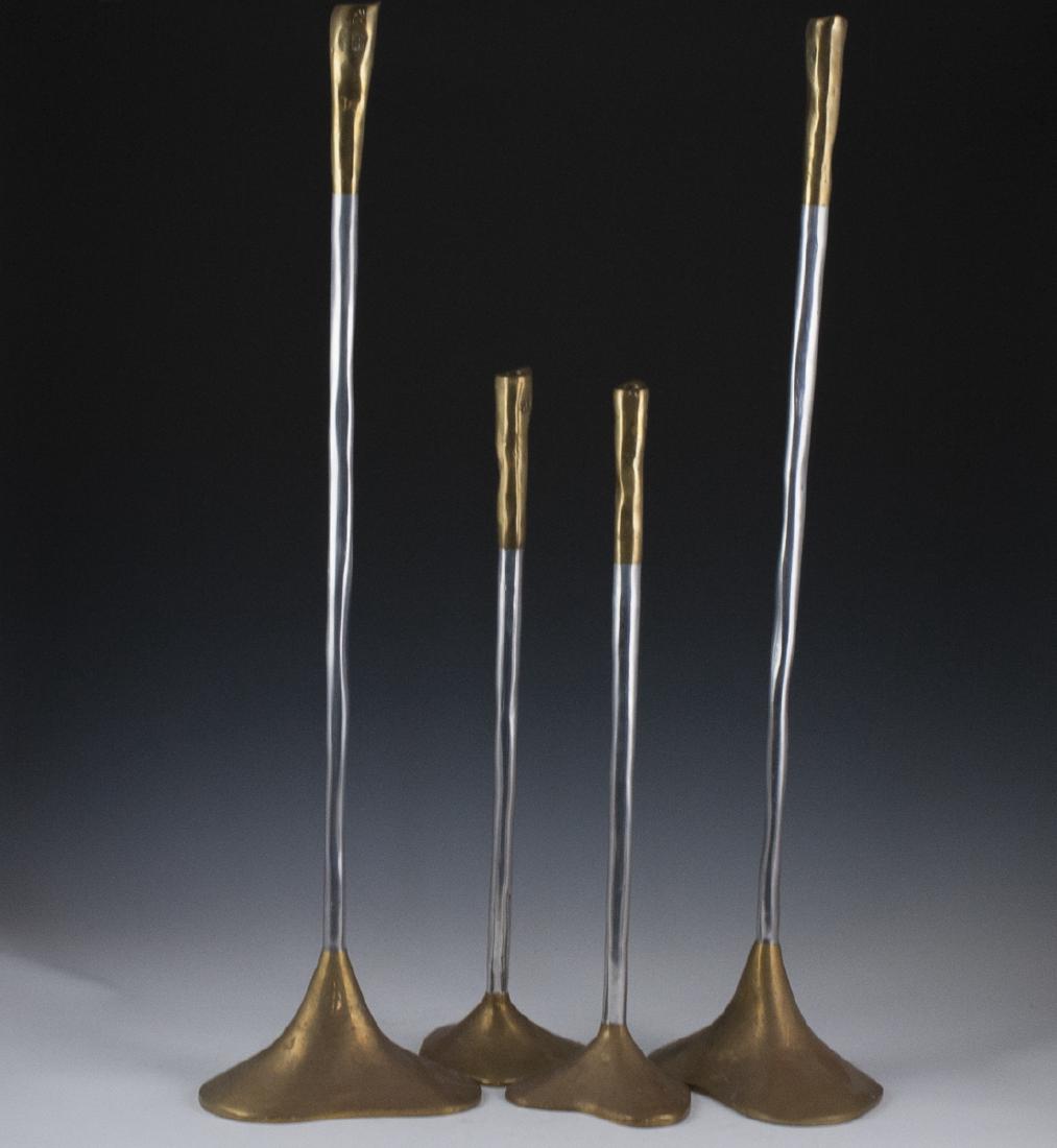 David Marshall Mixed Metal Candlesticks: DESCRIPTION: A set of four David Marshall mixed metal candlesticks composed of a pair of shorter, and a pair of taller candlesticks. Features brass bases, aluminum stems, and brass lined along the top