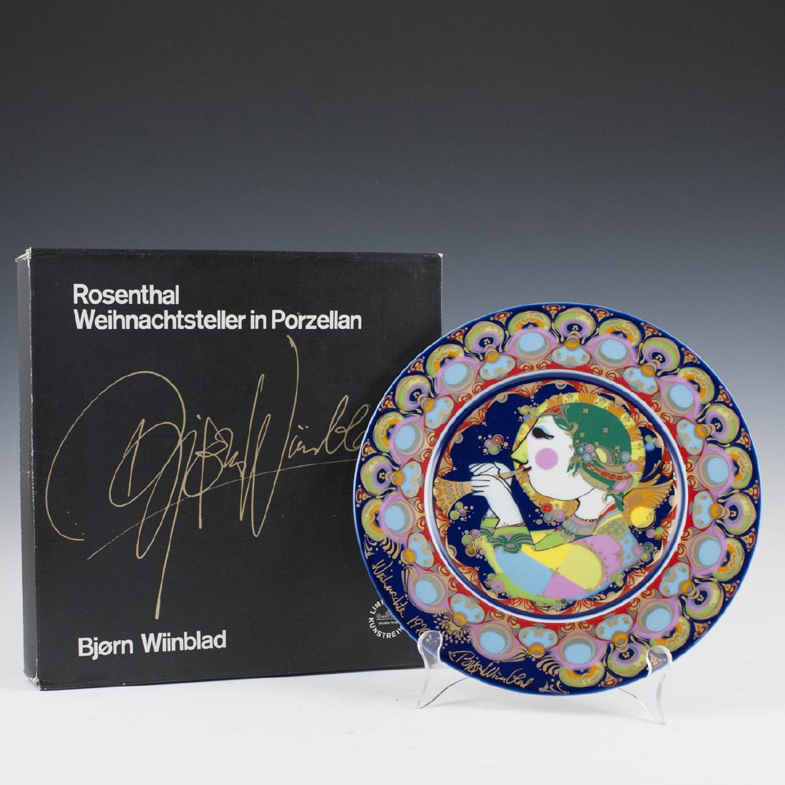 Rosenthal Bjorn Wiinblad "Weihnachtsteller" 1976 Plate: DESCRIPTION: A Rosenthal Bjorn Wiinblad "Weihnachtsteller" 197 porcelain plate. Features a vibrantly hued scene of an angel playing a flute. Finished with vibrantly hued patterns enveloping the scene 
