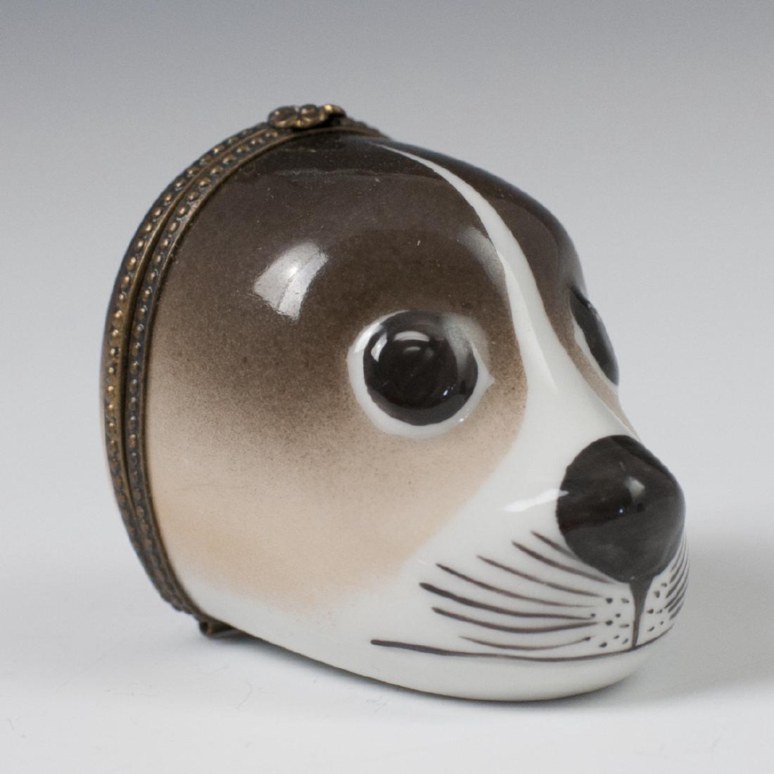 Parry Vieille Limoges Porcelain Pill Box: DESCRIPTION: A Parry Vieille Limoges porcelain pill box. Features a head of an affable seal motif with brass hardware along the hinge. Opens to reveal a hollowed interior. Marked "Limoges France Peint