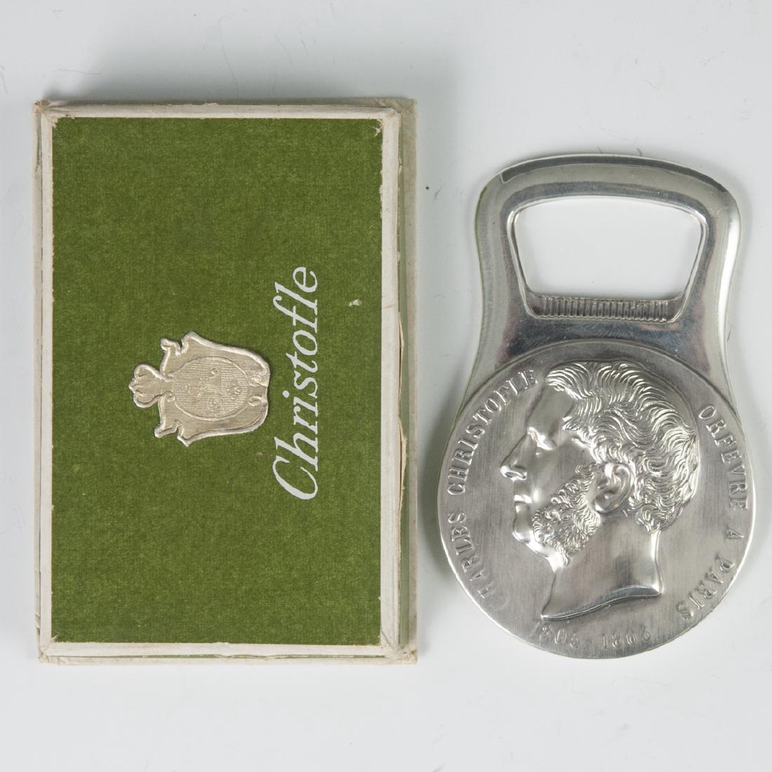 Christofle Gallia Bottle Opener: DESCRIPTION: A Christofle, Gallia metal, bottle opener. Features medallion commemorating Charles Christofle, "Orfevre A Paris". Verso features a wreath, enveloped by the words:"Fournisseur De L'Empere