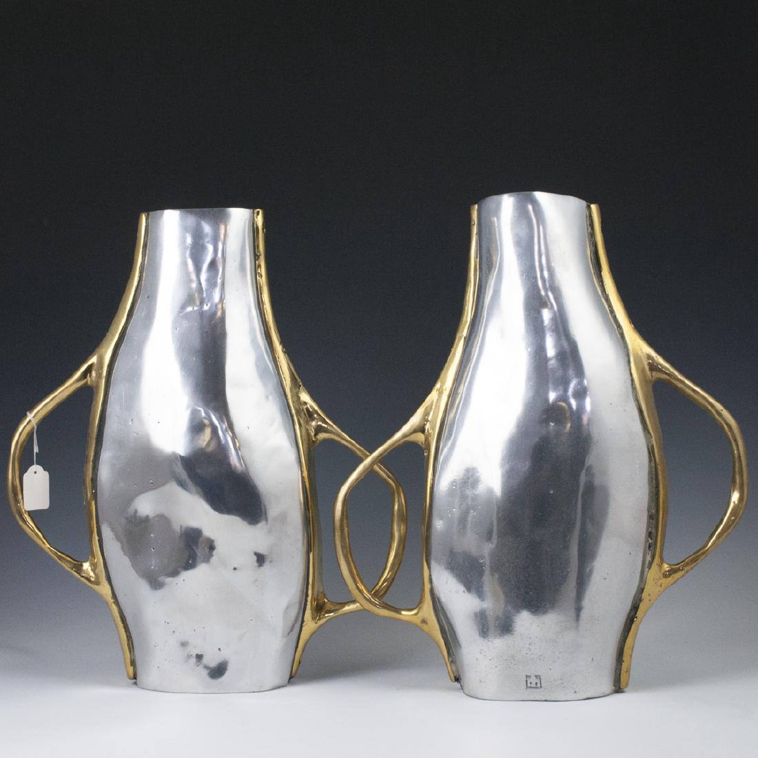 David Marshall "Orquidea I" Vase: DESCRIPTION: A David Marshall "Orquidea I" mixed metal flower vase. Composed of an aluminum body, embellished with winding brass handles. Stamped with David Marshall maker's mark. CIRCA: Late 20th-Ear