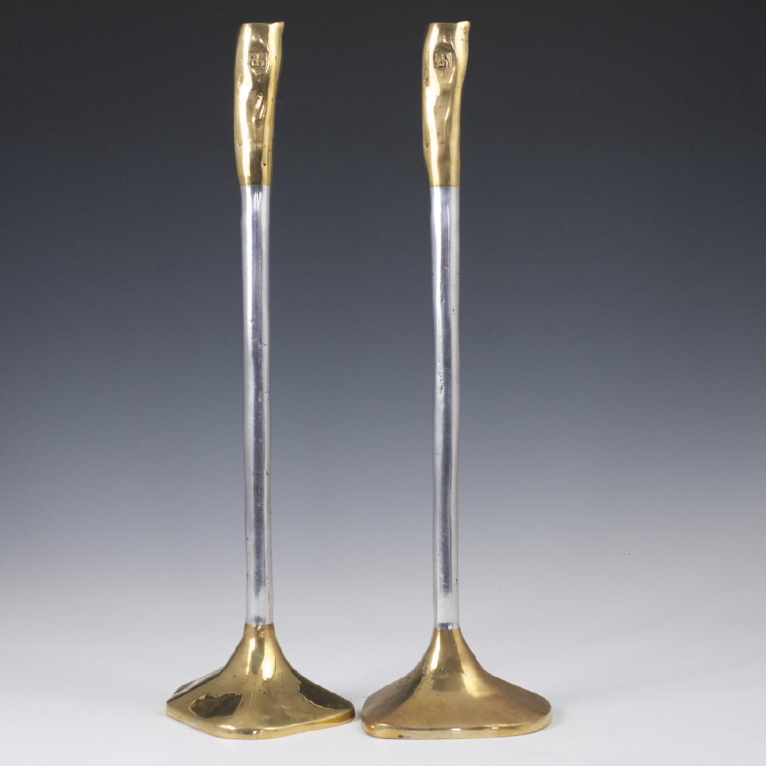 David Marshall "Medieval III" Candlesticks: DESCRIPTION: A pair of David Marshall, "Medieval III", patterned, mixed metal candlesticks. Features brass bases, aluminum stems, and brass along the tips. Marked with David Marshall stamps. CIRCA: La
