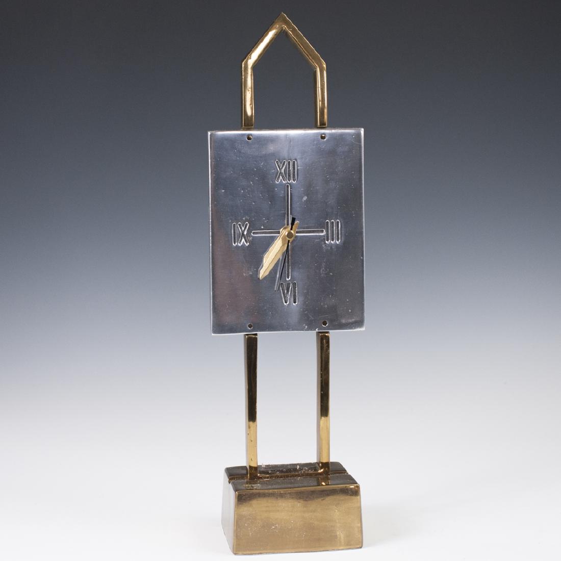 David Marshall "Teide" Clock: DESCRIPTION: A David Marshall "Teide" Clock. Composed of a brass base, stem, and an aluminum face with Roman numeral dials. Uses a battery operated movement. CIRCA: Late 20th-Early 21st Ct. ORIGIN: Sp