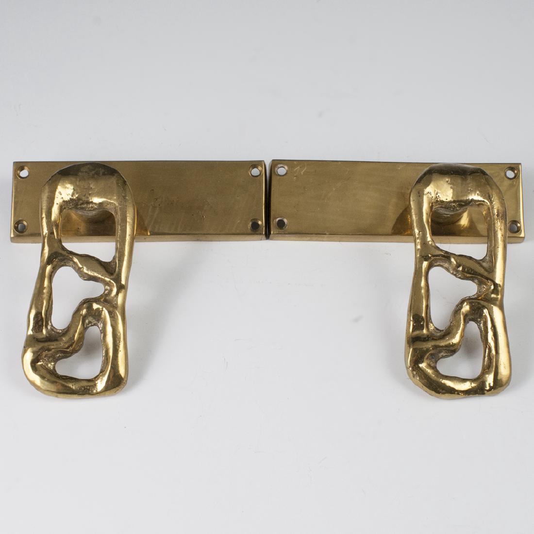 David Marshall Brass Door Knobs: DESCRIPTION: A pair of David Marshall, brass door knobs. Composed of overall brass foundations, designed with open work handles. Not marked. CIRCA: Late 20th-Early 21st ct. ORIGIN: Spain DIMENSIONS: H