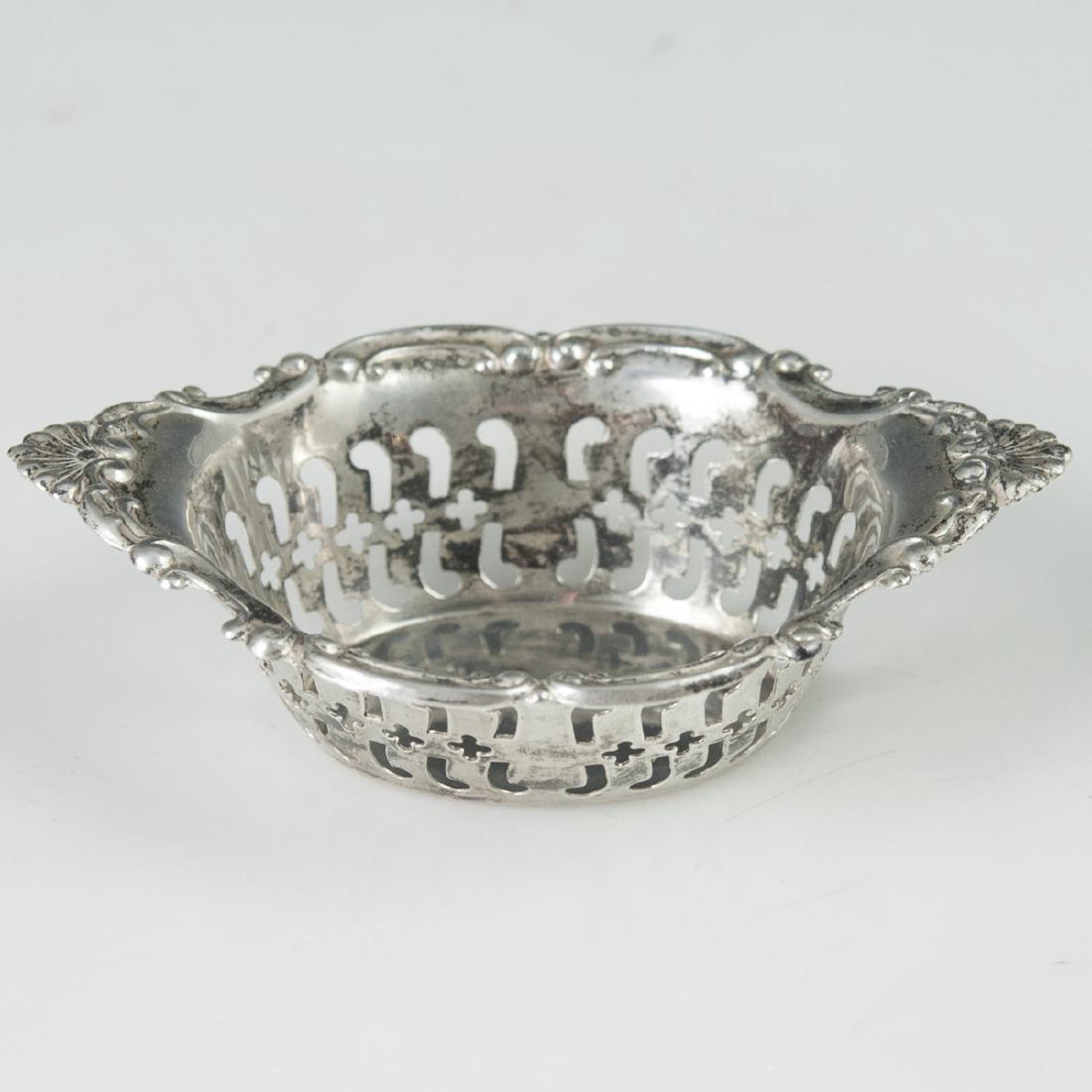 Birks Sterling Nut Dish: DESCRIPTION: A Birks sterling nut dish. Features scrolled rococo floral motifs along the rim, and garnished along the ovoid body with open work reticulations. Marked along the underside:"Birks Sterlin
