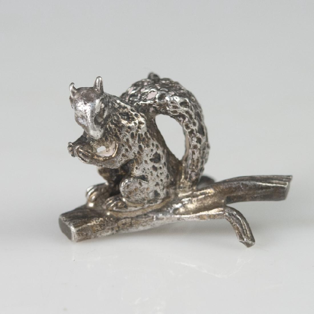 Tiffany & Co. Sterling Place Card Holder: DESCRIPTION: A Tiffany & Co. sterling place card holder. Features a motif of a squirrel atop a tree branch. Stamped:"Tiffany & Co. Sterling". CIRCA: Early-Mid 20th Ct. ORIGIN: USA DIMENSIONS: H:1 1/8"