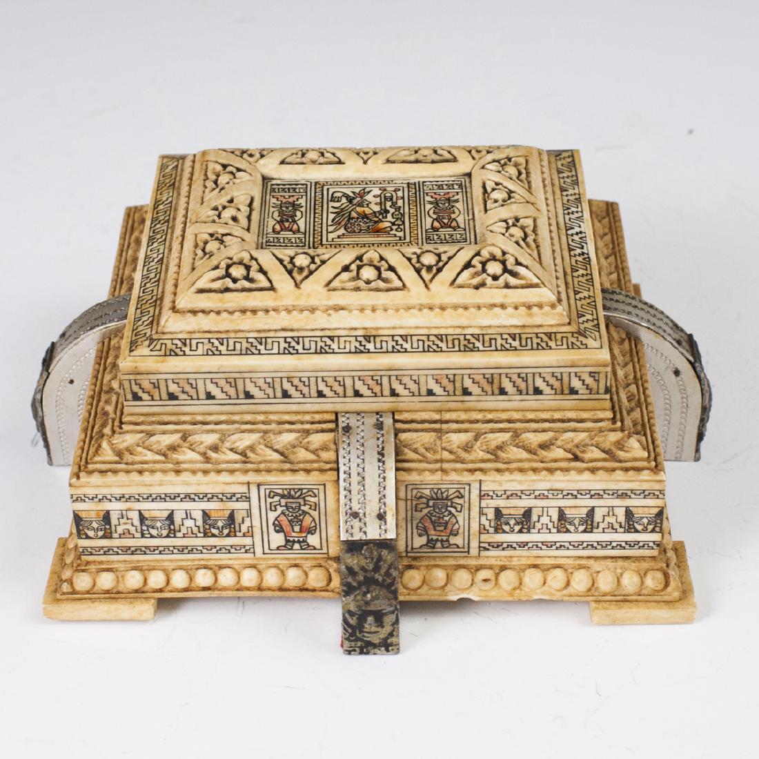 Mayan Style Carved Bone Box: DESCRIPTION: A carved bone and wood box. Features carved bone detailing with floral motifs, embellished with polychrome tiles with Mayan style decoration and figures. Finished with silver toned metal 