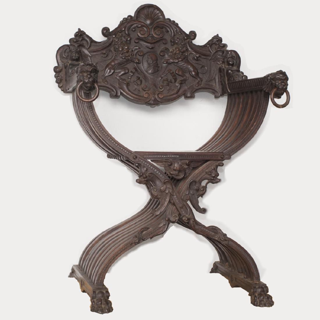 Antique Italian Savonarola Chair: DESCRIPTION: An antique Italian savonarola chair. Features carved lion paw motif feet, supporting the convex ribs, further carved with scrolled Rococo floral motifs below the seat. The armrests are ca