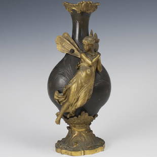 After Charles Georges Ferville-Suan (French 1847-1925): DESCRIPTION: An Art Nouveau, two tone bronze vase after Charles Georges Ferville-Suan (French, 1847-1925). Features a dore bronze base with scrolled rococo floral motif foliage, supporting the