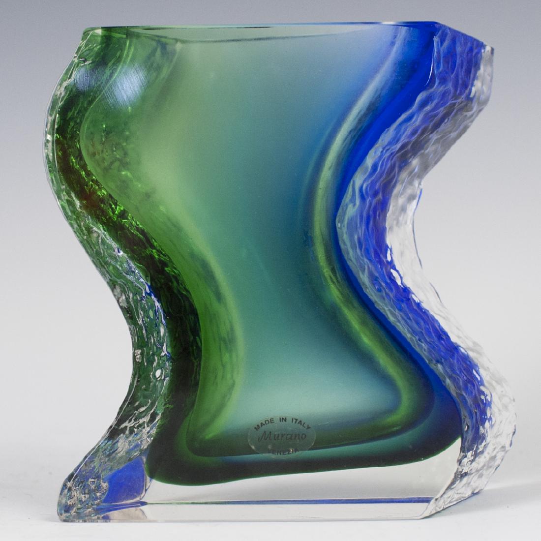 Murano Glass Vase: DESCRIPTION: A contemporary Murano glass vase. Features a waved design, garnished with textured sides and interior blue, and green hues. Finished with beveled edge work. Stickered:"Made in Italy Muran