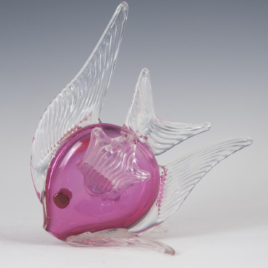 Murano Glass Tropical Fish: DESCRIPTION: A Murano glass tropical fish, embellished with a ruby glass center hued foundation and ridged, clear glass fins. CIRCA: Mid-Late 20th Ct. ORIGIN: Italy DIMENSIONS: H:9.25" L:8.25" W:5 5/8