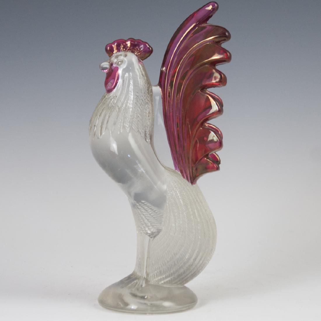 Murano Glass Cockerel: DESCRIPTION: A Murano glass cockerel. Features a clear glass body with textured detailing along its feathers. Finished with ruby hued detailing. Not signed. CIRCA: Mid-Late 20th Ct. ORIGIN: Italy DIME