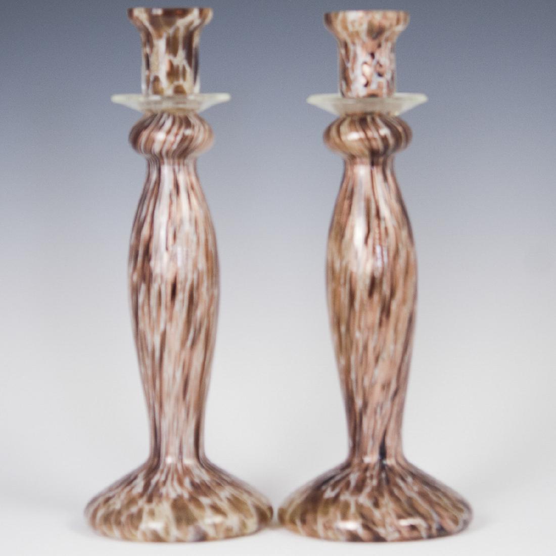 Murano Glass Candlesticks: DESCRIPTION: A pair of Mid-Century, Murano glass candlesticks. Composed of rotund bases, and tapering stems, garnished with brown, and copper glitter spotting throughout. CIRCA: Mid 20th Ct. ORIGIN: I