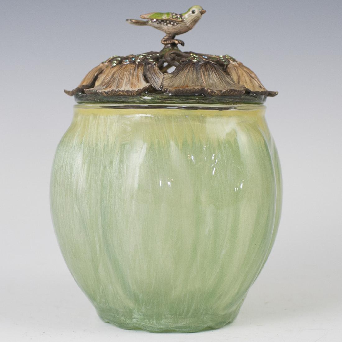 Jay Strongwater Enamel & Glass Potpourri Vessel: DESCRIPTION: A Jay Strongwater lidded potpourri vessel. Features a melon form, green hued, glass body, designed with an open work, enameled lid in the motif of overlapping flowers, centered by a bird.