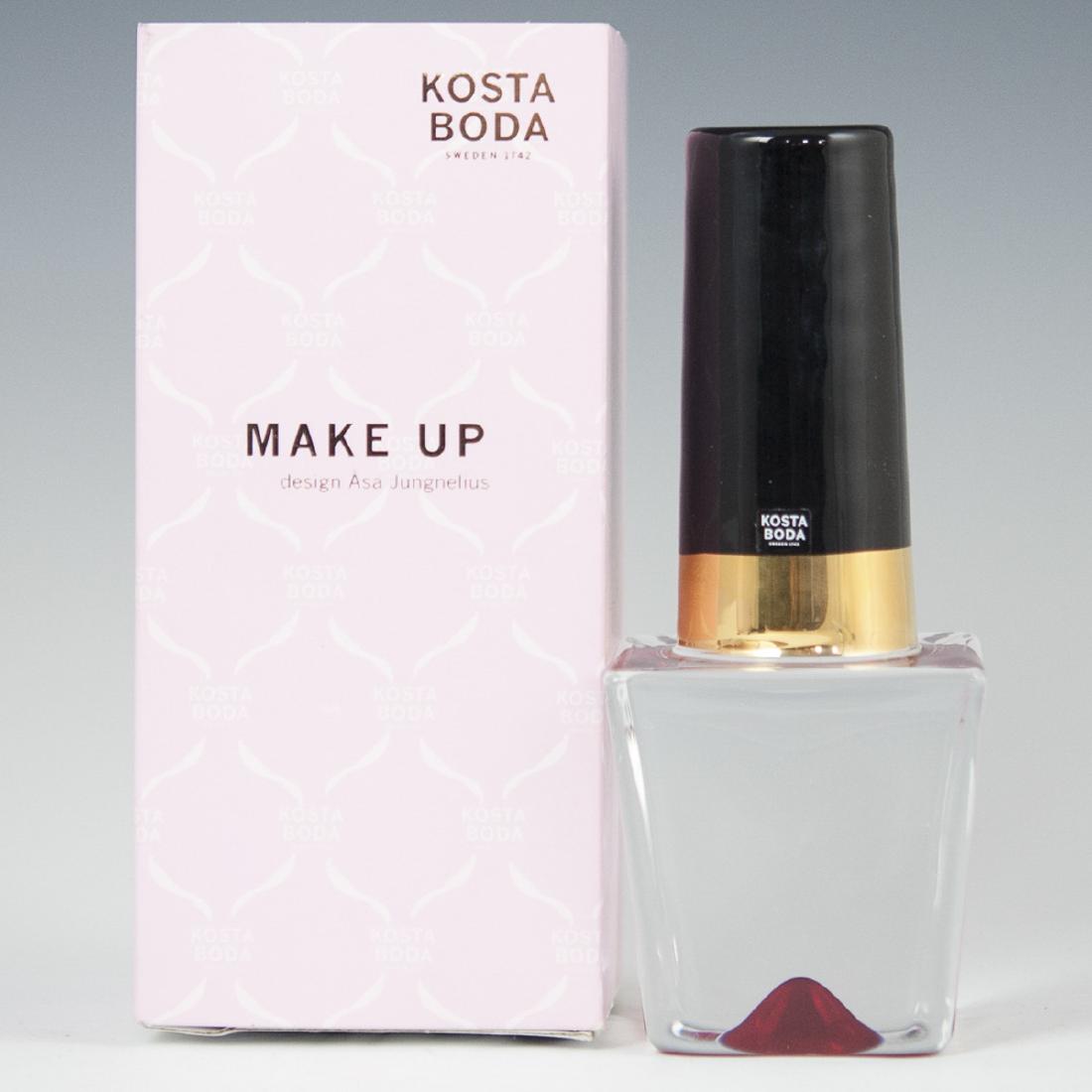 Kosta Boda Asa Jungenelius "Nail Polish" Crystal: DESCRIPTION: A Kosta Boda sculpture, designed by Asa Jungnelius from the"Make Up" line. Features a nail polish bottle form with hand painted accents along the top and a ruby red hued base. Signed:"Kos