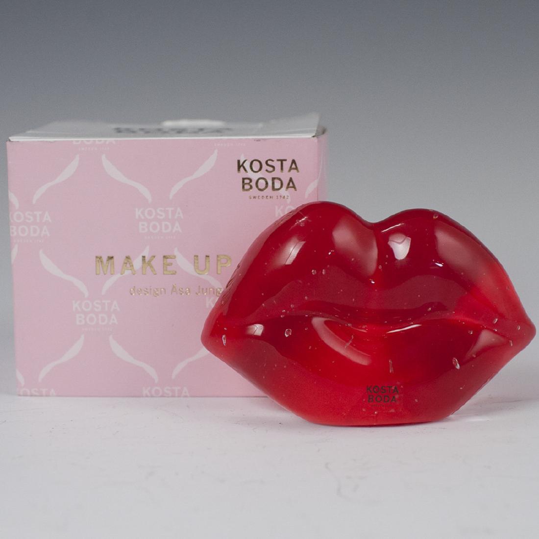 Kosta Boda Asa Jungenelius "Hot Lips" Crystal Sculpture: DESCRIPTION: A Kosta Boda sculpture, designed by Asa Jungnelius from the"Make Up" line. Features a pair of lips form handpainted on verso in red. Signed:"Kosta Boda A Jungnelius" and includes original